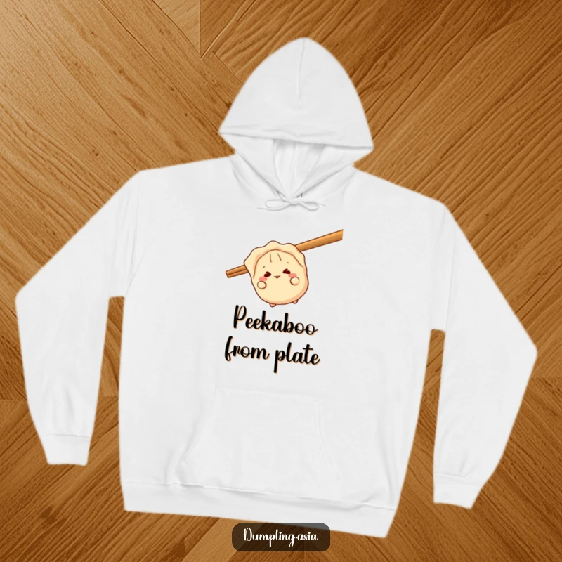 Funny gyoza hoodie, a giggling dumpling character, peeking playfully from behind a giant chopstick, cozy and comical.